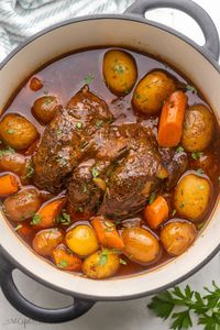 This easy oven Pot Roast recipe makes a truly delicious dinner centerpiece, perfect for the whole family for Sunday dinners or special occasions! With juicy beef seasoned in a homemade spice rub, it's cooked with potatoes and carrots until tender in a flavorful gravy made from scratch - it's the perfect pot roast! #dinner #recipe | pot roast recipe | beef roast | chuck roast | dinner ideas | dinner recipes | chuck roast recipes | sunday dinner | holiday dinner recipes