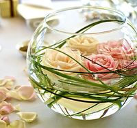 Floating Flower Centerpieces- this only in small square glass bowls  and one flower.