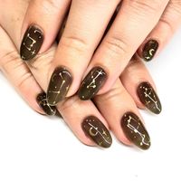 Constellation and galaxy nail art are SUPER perfect for moody winter time . Sheer black nails with gold constellation and star accent nails are the perfect subtle nail design to get you through the cold season. Click through for more nail art inspirations  from Katie Masters aka nail thoughts ! #galaxynails #constellationnails