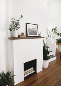 Learn how to build this modern, movable fireplace for an electric fireplace insert! #diy #fireplace #electricfireplace