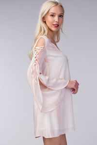 The Lyla Blush Bell Sleeve Shift Dress has us in awe! A blush pink tie dye print dances across woven fabric as it shapes a V-neck bell sleeve shift dress bodice with laced up cold shoulder tulip sleeves.