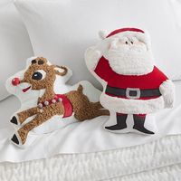 Top their bed or chair with playful pillows featuring their favorite reindeer and Santa. This bundle boasts super-soft fabrics and a glowing Rudolph nose, delivering seasonal cheer to your little one's decor. DETAILS THAT MATTER Rudolph(R) Santa Shaped Pillow Pillow is made from 100% cotton. Pom-pom is made of 100% acrylic. Reverses to a solid design in 100% cotton sheeting. Pillow is filled with 100% polyester. Features appliques and embroidery stitching on front of pillow. Insert is made of 10