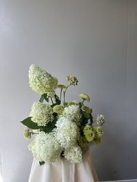 White snowball hydrangea, green zinnia and carnation floral centerpiece arrangement