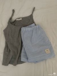 Relax in style with this cozy loungewear set, featuring a soft grey tank and comfortable striped shorts. Perfect for laid-back days at home or a peaceful night's sleep, this set combines comfort with casual elegance. Pin this for more loungewear inspiration, cozy outfit ideas, and everyday comfort looks. #Loungewear #CozyStyle #ComfyOutfit #RelaxedVibes #HomeWear #CasualComfort #ComfyAndChic #EverydayEssentials #TankAndShorts #ComfortFashion