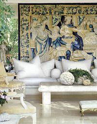 Michael Taylor's signature mix of giant white sofa, cannonball pillows, French fauteuils, rustic table.