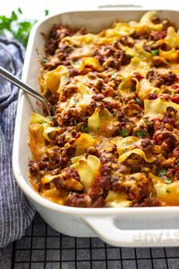 Sour cream beef noodle casserole is a dependable family favorite. With egg noodles in a rich beefy tomato sauce and cheesy sour cream layers.