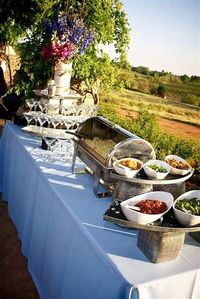 an outdoor buffet table with food