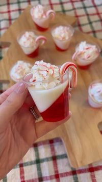 Recipe: - strawberry jello pack - cold water - @smirnoff peppermint vodka - gelatin - sweetened condensed milk - whip cream and crushed. candy cane for topping Follow the instructions on a box of jello I used strawberry flavored). I subbed some of the cold water for 3-4 ounces of peppermint vodka. Fill a shot glass half way and then freeze on a tilt (about 30 min.) used a muffin tin to hold it). Make clear gelatin(follow pack instructions) and then add 2 tablespoons of sweetened condensed milk (this will turn it white, you can also add more vodka here if you'd like). Pour liquid in remainder of shot glass. I froze for additional 15 minutes but you can also refrigerate. Top with whip cream & crushed up candy canes.♥️🎄