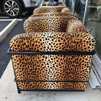 Dramatic faux leopard upholstered chairs in a metal framework. Visually staning and built for comfort.