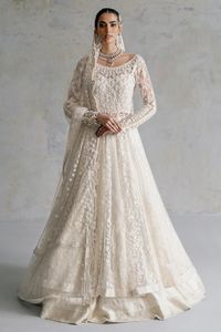 Nikkah Dress in Pishwas Frock and White Lehenga Style is an epitome of elegance and royalty that will give the gorgeous bride a head-turning look on her big day. Perfect stitching and premium quality of the fabric makes this beautiful Pishwas Dress your priority for the wedding. Pakistani Bridal Pishwas: Pakistani Bridal Pishwas has an elegant white color and it will give you a head-turning look on the most important day of your life. Lavish floral embroidery and sequins make this beautiful Pish