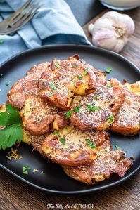 Parmesan Smashed Potatoes served with roasted garlic aioli is an easy and hearty side dish. #recipe from thissillygirlskitchen.com #potatoes #sidedish #potatosidedish #smashedpotatoes #parmesanpotatoes #garlic #garlicaioli