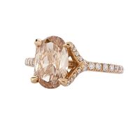 Champagne Oval Diamond Engagement Ring in Rose Gold. Unique engagement ring by Irina Ferry is 18 karats rose gold with a 2.54 carat fancy champagne oval diamond at center, and set on a micropave diamond band with 0.32 carats of diamonds. This rare, one of a kind champagne gem has a hint of yellow and pink