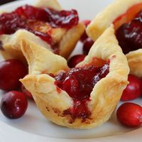 Cranberry Kisses - puff pastry, left over cranberry sauce, and brie or goat cheese. Looks like the *perfect* Christmas or NYE appetizer  (I might try this with raspberry chipotle sauce)