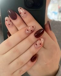 red nails with hearts and nail stones