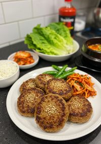 Tteokgalbi on a Plate with Rice and Kimchi