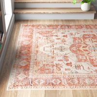 This area rug showcases a floral motif inspired by Persian patterns, bringing a boho feel to your space. It's power-loomed in Turkey from cotton, chenille, and polyester, and it features a traditional central medallion design. This rug is purposefully distressed for a laid-back feel, and it has a neutral orange and beige palette. We love how its 0.17" low pile height makes it the ideal base for busy spaces like your entryway, hallway, or living room. To care for this area rug, vacuum it with no