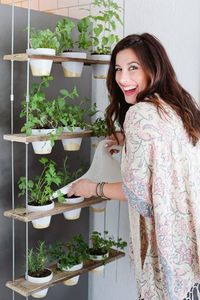 Make this Custom Potted Hanging Herb Garden. An easy DIY for your home made from pallet wood and inexpensive terra cotta pots! - Click through for the full tutorial.