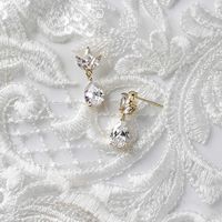 Simple and classic minimalist cubic zirconia earrings designed with a pear drop hanging from three marquise jewel leaves. Truly perfect for any special occasion or your bridesmaids! Post back, 7/8 inches long. Rhodium, gold or rose gold plated, grade AAA cubic zirconia, nickel, cadmium, and lead free.