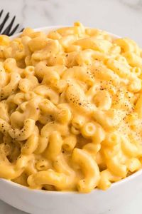 Made with a mix of cheddar and American cheeses, this Crock Pot Mac and Cheese is uber creamy and super easy to make. Just add all of the ingredients to the slow cooker and cook on low. No need to precook the pasta!