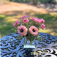 This classy real touch ranunculus flower arrangement includes a variety of gorgeous pink faux ranunculus flowers in a glass vase for the perfect modern silk flower arrangement. Add a pop of color to your home decor with this elegant silk floral arrangement, perfect for a bedroom nightstand, foyer table, coffee table, or in the living room for all to enjoy! #pinkflowerarrangement #ranunculus #silkflowerarrangement #homedecor #smallfloralarrangement