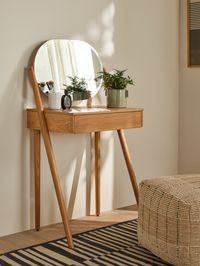 With a clean, modern aesthetic our Bow bedroom furniture range is made from predominantly solid oak and oak veneers for a durable and visually striking finish. You'll enjoy the beautiful natural grain of the wood, as well as enduring style and an elegant profile that will stand the test of time.  This modern dressing table is perfect for small spaces in your bedroom. Its contemporary silhouette features a discreet drawer for convenient storage, while its oval shaped mirror is ideal for getting r