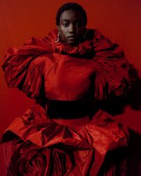 Photographed backstage at the Autumn/Winter 2019 show, a silk taffeta dress in saturated deep red recalls the rose in full bloom. A fitted tucked bodice explodes with drapes into a full skirt with petal folds. The dress references the Red Rose of Lancaster.