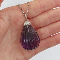 Impressive Antique Early Art Deco Amethyst and Diamond Pendant 💜 The large amethyst is carved with fluted detail to look like a shell with a diamond set cap and pendant bale. #amethystpendant #carvedamethyst #amethystanddiamond #artdecojewellery