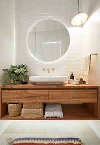 **Week 4, Main Bathroom** Hoping to replicate their success in the first ensuite reveal with their [main bathroom], Andy and Deb continued their relaxed neutral theme, pairing hand-made tiles with a timber vanity and gold tapware.