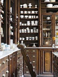 antique style ceramic store with carved wood apothecary hutch | Kühn Keramik in Berlin, Germany