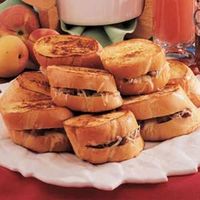 French toast gets special treatment from Edna Hoffman of Hebron, Indiana. She stuffs each thick slice with Swiss cheese and sizzling sausage for a satisfying meal-in-one.