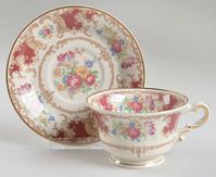 Footed Cup & Saucer Set in the Romance Maroon pattern by Syracuse. Old Ivory, Maroon Insets, Flowers 2 3/8"