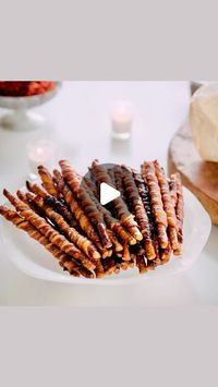 Elizabeth Gourlay Heiskell on Instagram: "Sweet, salty, and irresistibly crispy—these bacon bites are always a hit. Be sure to move them off the pan right away to avoid any sticky situations!🥨🥨

2 cups packed light brown sugar
22 thin bacon slices
22 breadsticks or pretzel sticks"