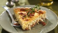 Bring the fabulous flavors of France to your dinner table with this delightful quiche baked with crumbled bacon and Swiss cheese.