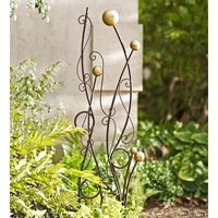 This Abstract Iron Trellis is an eye-catching combination of wrought iron circles, arcs and curlicues topped off with five golden spheres. Sure to make an artistic statement in your landscape, this iron garden trellis is far removed from your everyday lattice or bamboo stakes. Our trellis is so lovely, in fact, that you might find yourself keeping your plants away from it, though they will be eager to weave their way through the intricate twists and turns. Two long, sturdy stakes ensure secure p