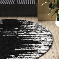 This plush indoor area rug adds a cushioned foundation and plenty of industrial style to your hardwood or tile floors. It features a mix of geometric and abstract designs in hues of black and white for a warm and versatile look. It's power-loomed from polypropylene, so it stands up to spills and stains, and it has a jute backing. We love how the braided fringe accents on the end add an extra layer of texture. Plus, the high 1.5" pile height is ideal for rolling out in rooms with low foot traffic