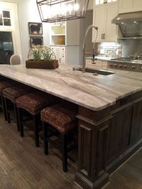 Transitional farmhouse with Leathered granite, fantasy brown color, stained island with white kitchen