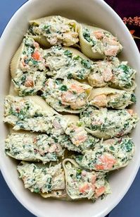 Salmon stuffed shells combines two foods, pasta and salmon, into one delicious and satisfying meal. The shells are filled with a creamy mixture of salmon, ricotta cheese, and herbs, then baked to perfection with a layer of melted cheese on top. Here is you can make the delicious salmon stuffed shells recipe at home.