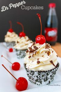 Dr Pepper Cupcake | Sassy Girlz Blog Chocolate and Dr Pepper Cupcakes topped with whipped Dr Pepper Frosting and complete with a maraschino cherry and chocolate shavings on top! What more can you ask for?