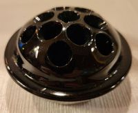 Vintage 13 hole black amethyst glass flower frog marked Pat'd April 11, 1916. The frog is in good condition with just a small chip at the edge of the center hole 9see photo), no cracks or repairs. It is 2" high and 3-3/4" across.