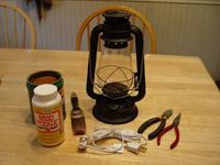 Turn an oil lantern to a "rusty," electric, primitive lantern.