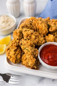 These Fried Oysters are tender on the inside with a crispy golden exterior. Serve them as an appetizer or an entree with you favorite sauces. #southernseafoodrecipes #southernfood #friedoysters #easyoysterrecipes #oysters #easyfriedoysters #seafoodrecipes