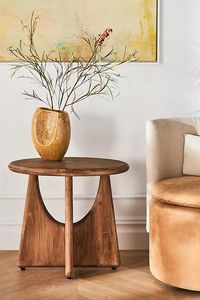 Ideal for a farmhouse-style interior, this wooden side table boasts intricately-shaped legs supported by a rounded top for a just right touch of rustic elegance. For ordering assistance and more, please contact us For aesthetic advice and tips to help decorate your space, enjoy our complimentary home styling services For more information on the materials and techniques of this piece, click here Juniper Side Table by Anthropologie in Beige