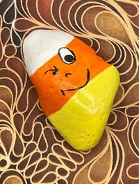 "Cartoon Face Winking Candy Corn, Hand Painted Rock Measures approximately:  Height 2\" Length 1.25\" Depth .5\" ✽ My painted rocks are natural creek rocks collected locally in middle Tennessee and hand painted by me.  ✽ Your stones are handpicked and hand painted by me with love! Each is a one-of-a-kind piece of art! I hope they bring much joy, happiness, and a smile to you.   ✽ These are natural creek rocks so each stone is unique and no two rocks are identical.  The size, shape, and texture may vary slightly. ✽ Each stone design is drawn by hand, painted with acrylic paints, sealed, and packaged with care to send to your home from my home in middle Tennessee.   ✽ All my creations are sealed to protect and preserve the quality. ✽ Want a custom design?  If you don't find exactly what you'