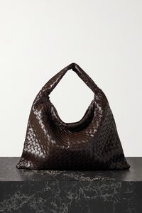 This beautifully crafted tote is undoubtedly Bottega Veneta - it's woven from strips of glossy brown leather using the house's signature intrecciato technique. Defined by its slouchy shape, it's sized to hold all your essentials and has a curved shoulder strap.