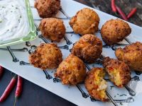 Upgrade this fun carnival treat with flaky chunks of lobster in a buttermilk-cornmeal batter. Once the hushpuppies are fried and golden, Guy serves them with a tangy horseradish cream dip.