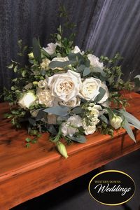 White Roses (x2 types), Carnation, Lisianthus, Spray Rose, Fressia, Eucalyptus and Pittosporum