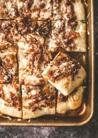 White pizza (Pizza Bianca) topped with caramelized onions and Gruyere cheese. This is a fun alternative to classic red sauce pizza.