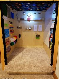 Good idea: This parent took the sensory board to the next level by covering the walls of their parent's cubby house with play things