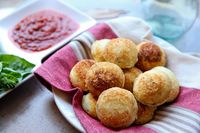 Sweet and Savory Ebeleskiver Fun- Two-Cheese Puffs with Marinara -1 cup cake flour -3/4 teaspoon baking powder -1/4 teaspoon salt -2 large eggs, separated -1 cup whole milk -3 tablespoons unsalted butter, melted and slightly cooled -1/2 cup freshly grated Parmesan cheese -2 1/2 tablespoons chopped fresh basil -3 1/2 tablespoons finely diced mozzarella -1 cup purchased marinara sauce