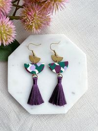 Stylish polymer clay earrings with a small tassel. These pretty one-of-a-kind dangles are lightweight and easy to wear. Main drop piece is made from polymer clay Ear post (through ear) is surgical steel Tassel is cotton